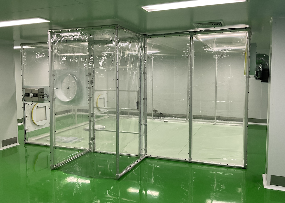 Positive Pressure, Flexible Film (Softwall) Cleanroom that is completely enclosed and is designed to provide a completely controlled production environment so chronic studies do not have to be started over due to contamination of control or test specimens. Note: The chamber is not a laminar airflow design but is completely enclosed.